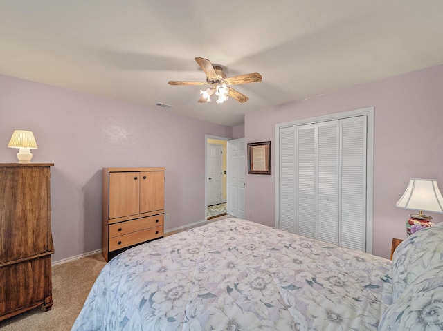 carpeted bedroom featuring ceiling fan and a closet