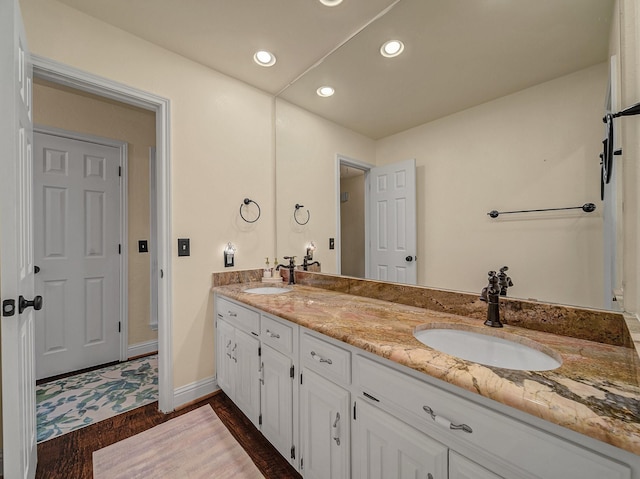 bathroom featuring hardwood / wood-style flooring and vanity