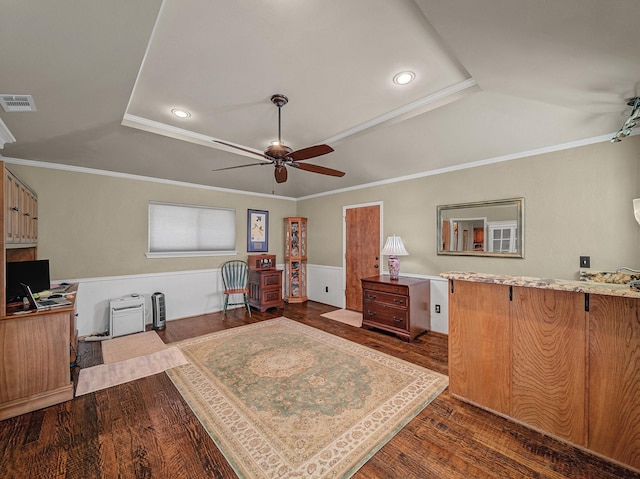 office space with a raised ceiling, ceiling fan, dark hardwood / wood-style floors, and ornamental molding