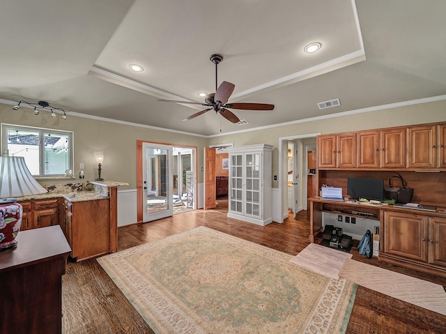 interior space featuring a raised ceiling, french doors, dark wood-type flooring, and crown molding