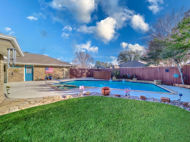 view of swimming pool with a lawn and a patio