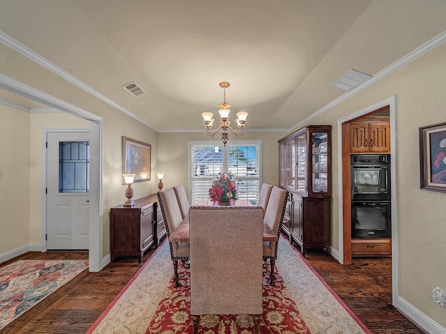 dining room with dark hardwood / wood-style flooring, ornamental molding, and an inviting chandelier