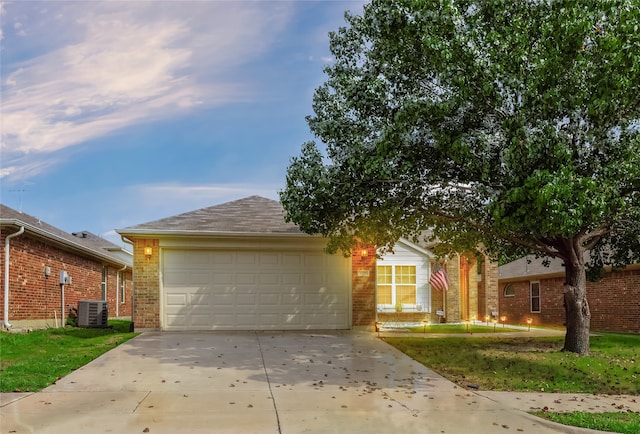 ranch-style home with a garage and cooling unit