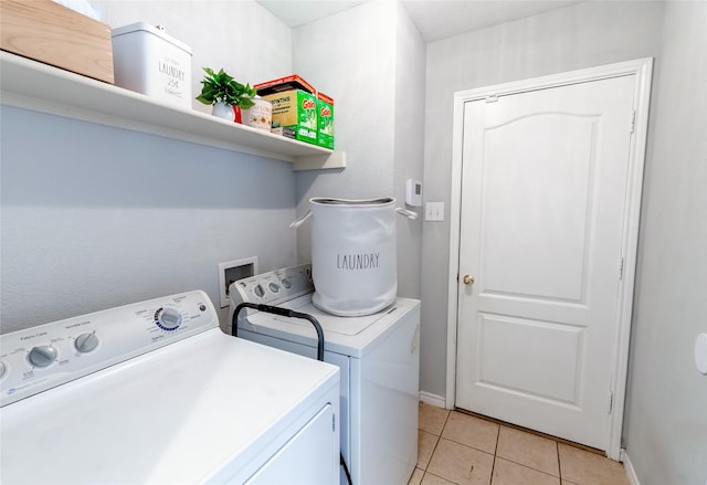 3729 Cook Ct, Fort Worth, TX 76244 - laundry room with washer and clothes dryer, light tile patterned floors, and baseboards