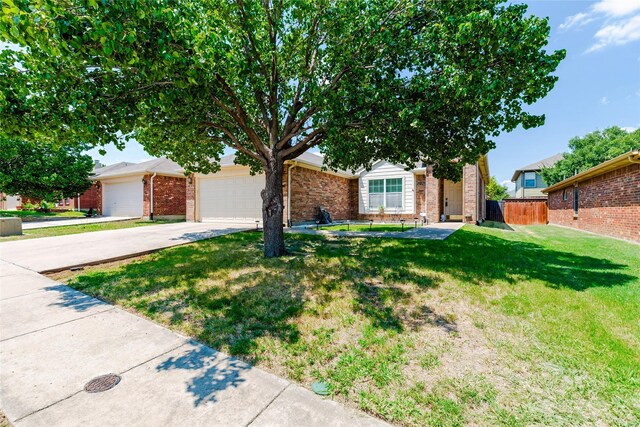 view of front of home with a front yard and a garage