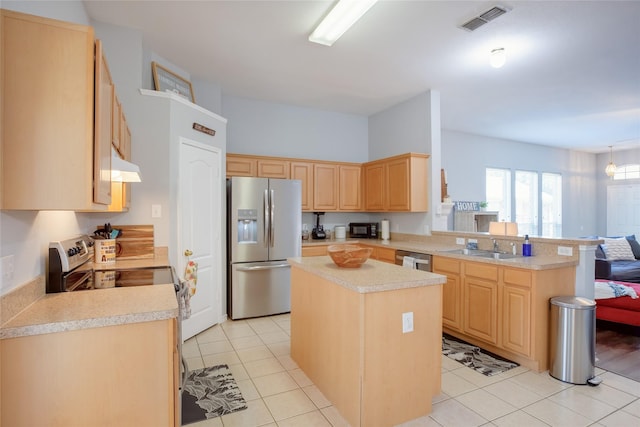 3729 Cook Ct, Fort Worth, TX 76244 - kitchen featuring appliances with stainless steel finishes, light brown cabinetry, light countertops, under cabinet range hood, and a peninsula