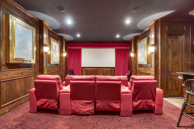 home theater featuring wood walls and carpet flooring