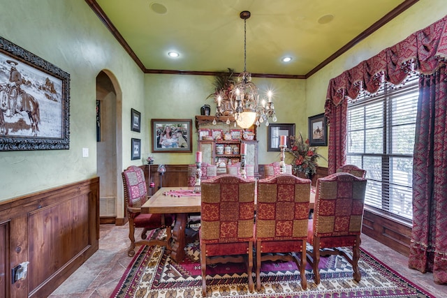 dining space featuring crown molding and a chandelier