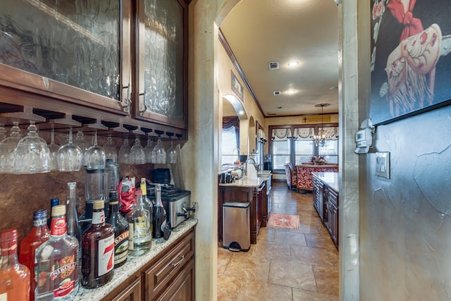 kitchen with light stone counters and pendant lighting