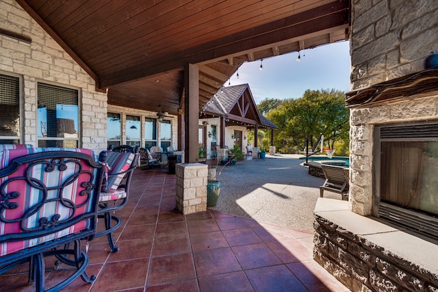 view of patio / terrace featuring an outdoor stone fireplace