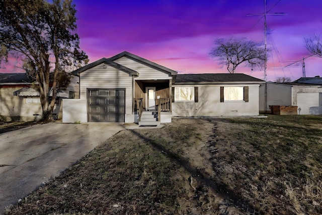 single story home featuring a yard and a garage