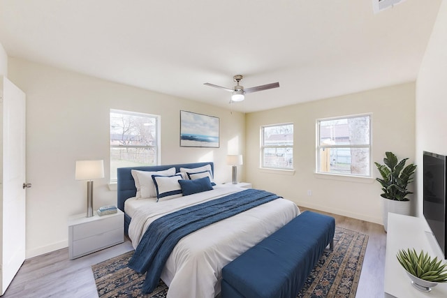 bedroom with ceiling fan and light hardwood / wood-style flooring