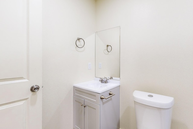 bathroom featuring toilet and vanity