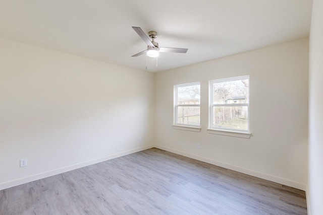 spare room featuring ceiling fan and light hardwood / wood-style floors