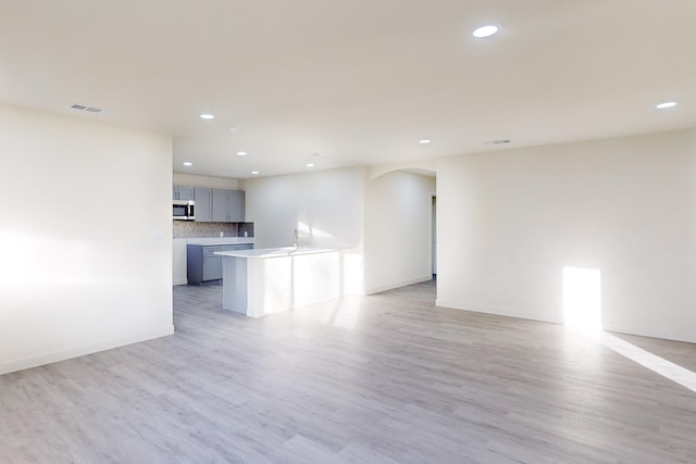 unfurnished living room featuring light wood-type flooring