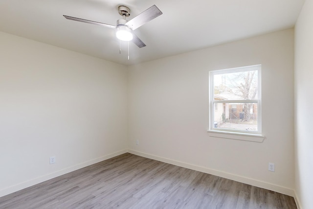 spare room featuring ceiling fan and light hardwood / wood-style flooring