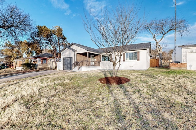 ranch-style house featuring a garage, a front yard, and a porch