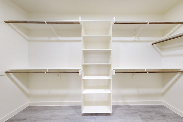 spacious closet featuring hardwood / wood-style floors