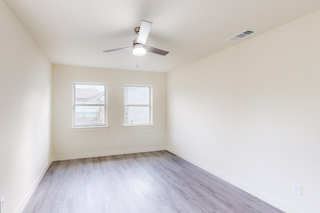 unfurnished room featuring light wood-type flooring and ceiling fan