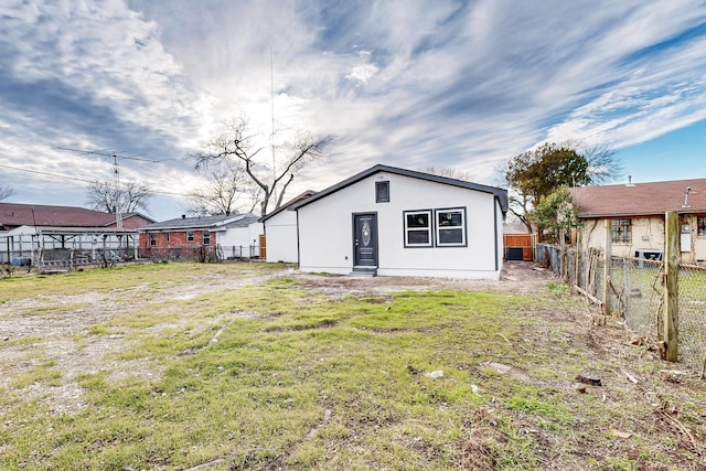 rear view of property with a yard