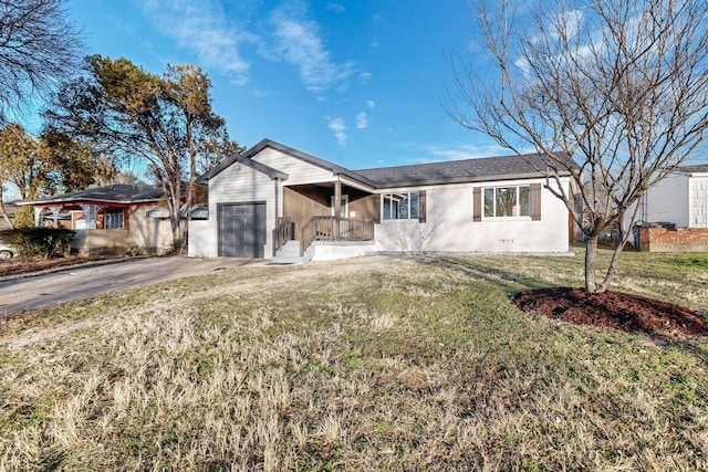 ranch-style house with a front yard and a garage