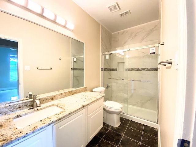 bathroom with toilet, walk in shower, and vanity