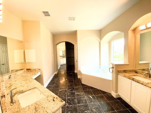 bathroom with vanity and a tub