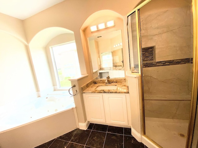 bathroom featuring plus walk in shower and vanity