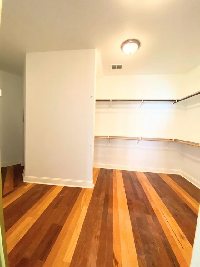 walk in closet with hardwood / wood-style floors