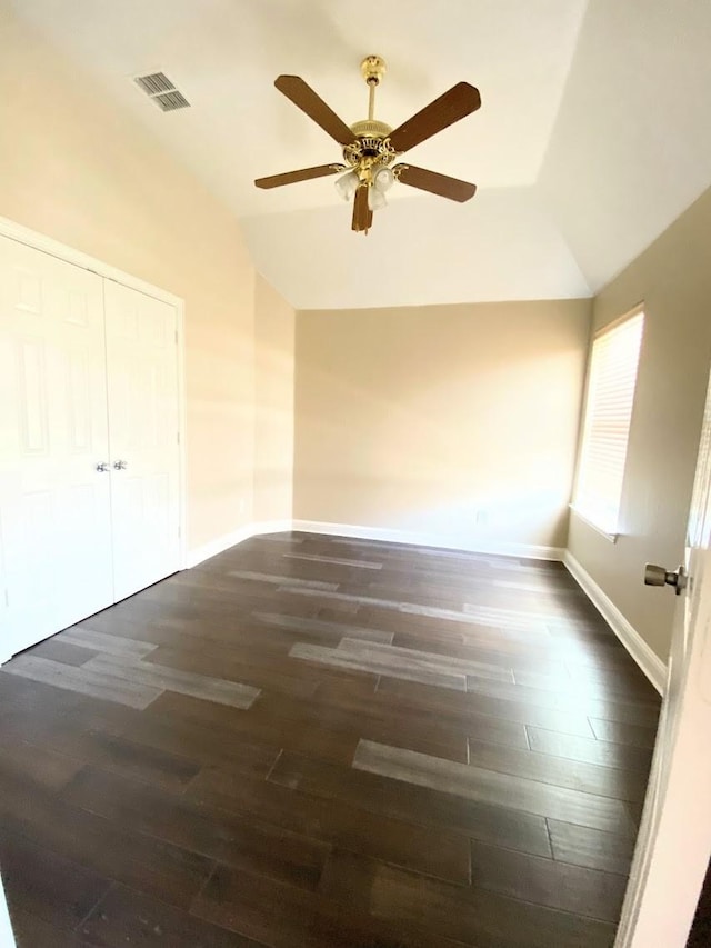 unfurnished room with ceiling fan, dark wood-type flooring, and vaulted ceiling