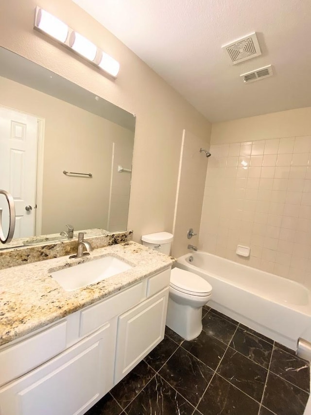 full bathroom with tiled shower / bath combo, vanity, and toilet