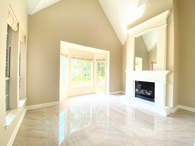 unfurnished living room featuring vaulted ceiling