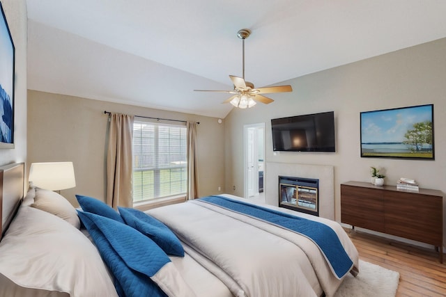 bedroom featuring ceiling fan, vaulted ceiling, and light wood-type flooring