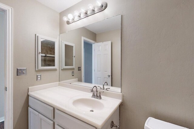 full bathroom with tile patterned flooring, enclosed tub / shower combo, vanity, and toilet