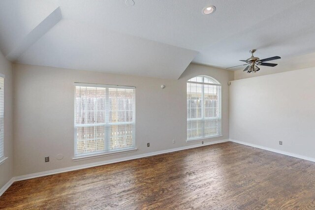 foyer entrance with vaulted ceiling, ceiling fan, and dark hardwood / wood-style flooring