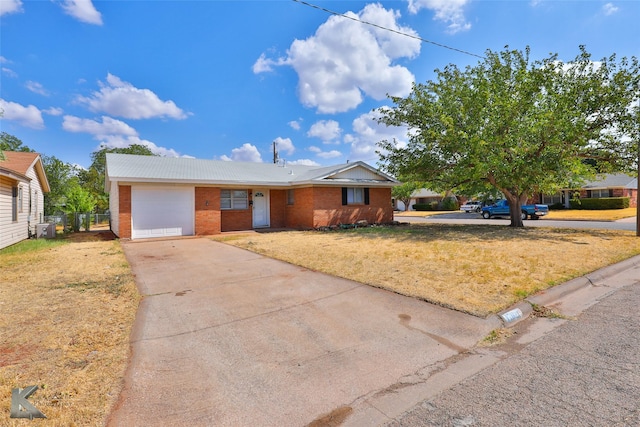 single story home with a garage and a front yard