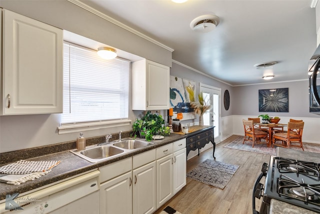 kitchen featuring ornamental molding, light hardwood / wood-style floors, white cabinets, and sink