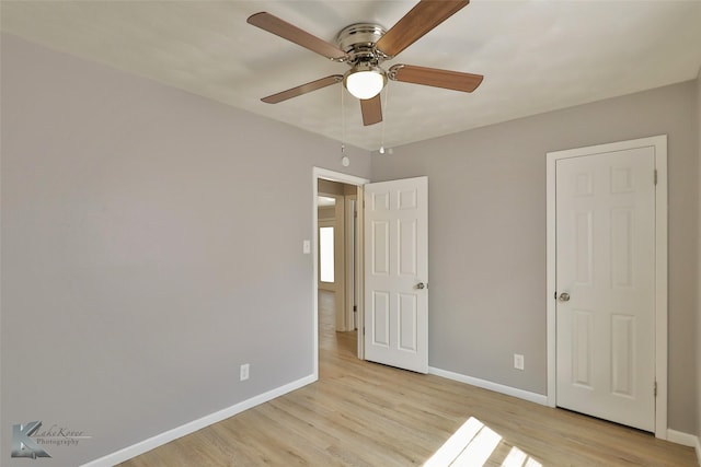 unfurnished bedroom featuring light wood-type flooring and ceiling fan