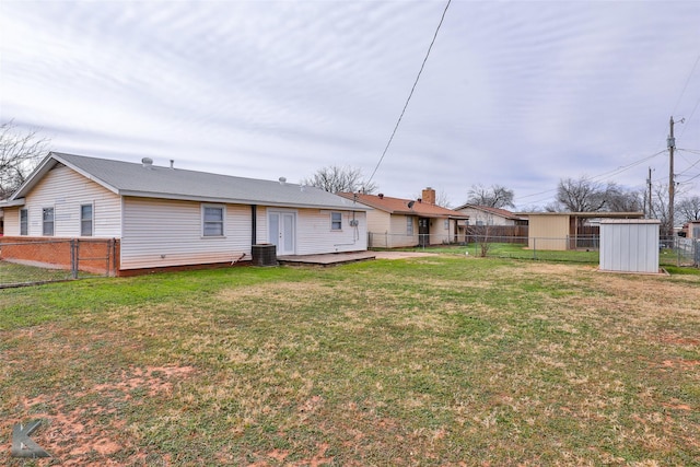 back of property featuring a lawn and central air condition unit