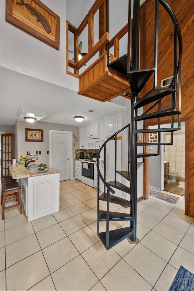 stairway with tile patterned floors