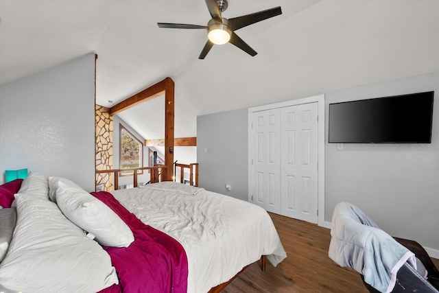 bedroom with ceiling fan, vaulted ceiling with beams, a closet, and dark hardwood / wood-style floors