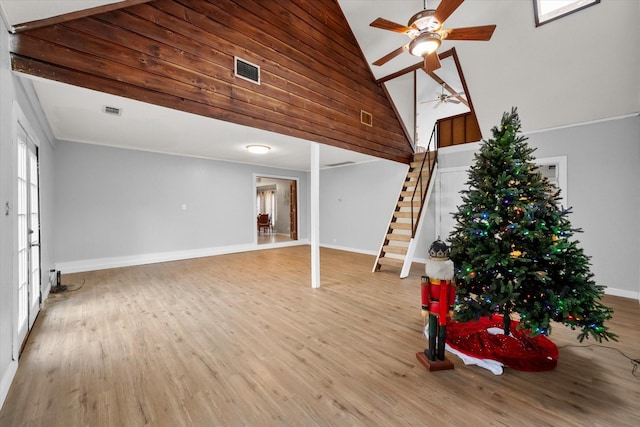 unfurnished living room with high vaulted ceiling, wood-type flooring, and ceiling fan