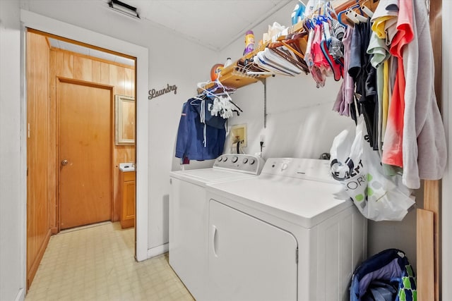 clothes washing area with separate washer and dryer