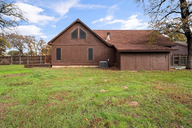 back of property featuring a yard and central air condition unit