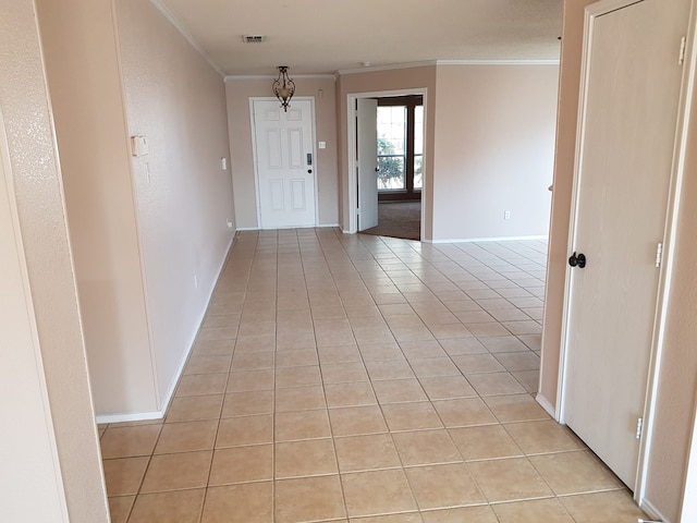 hallway with light tile patterned floors and ornamental molding