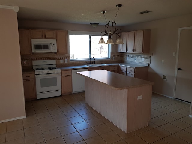 kitchen featuring sink, white appliances, backsplash, and a kitchen island