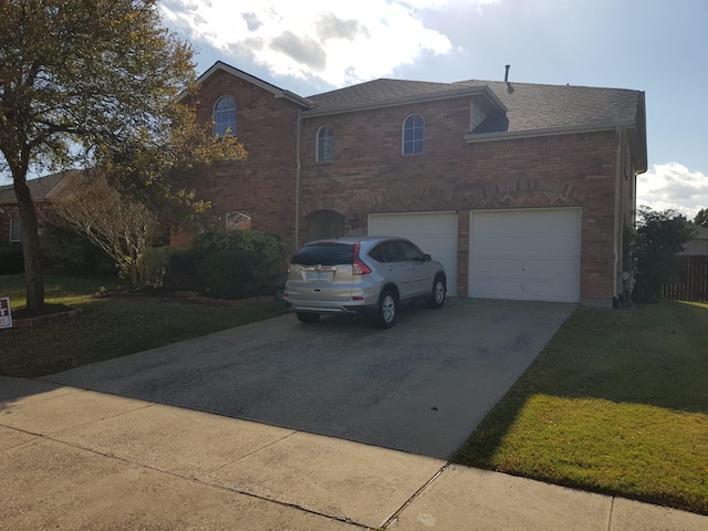 view of front of home featuring a garage and a front lawn