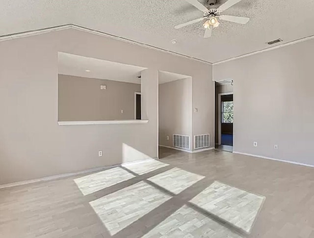 empty room featuring ceiling fan, a textured ceiling, and hardwood / wood-style floors