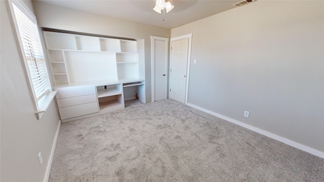 unfurnished bedroom featuring ceiling fan and light colored carpet