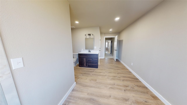 hall featuring light hardwood / wood-style floors and sink